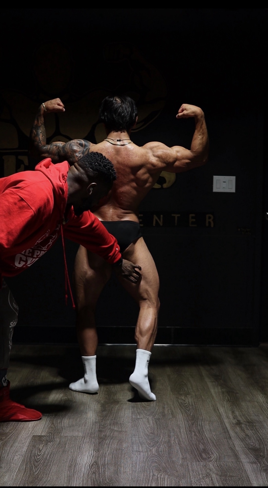 Russell Holland coaching a client through posing adjustments
