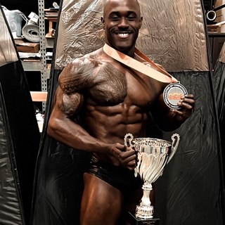 Russell Holland holding trophies
