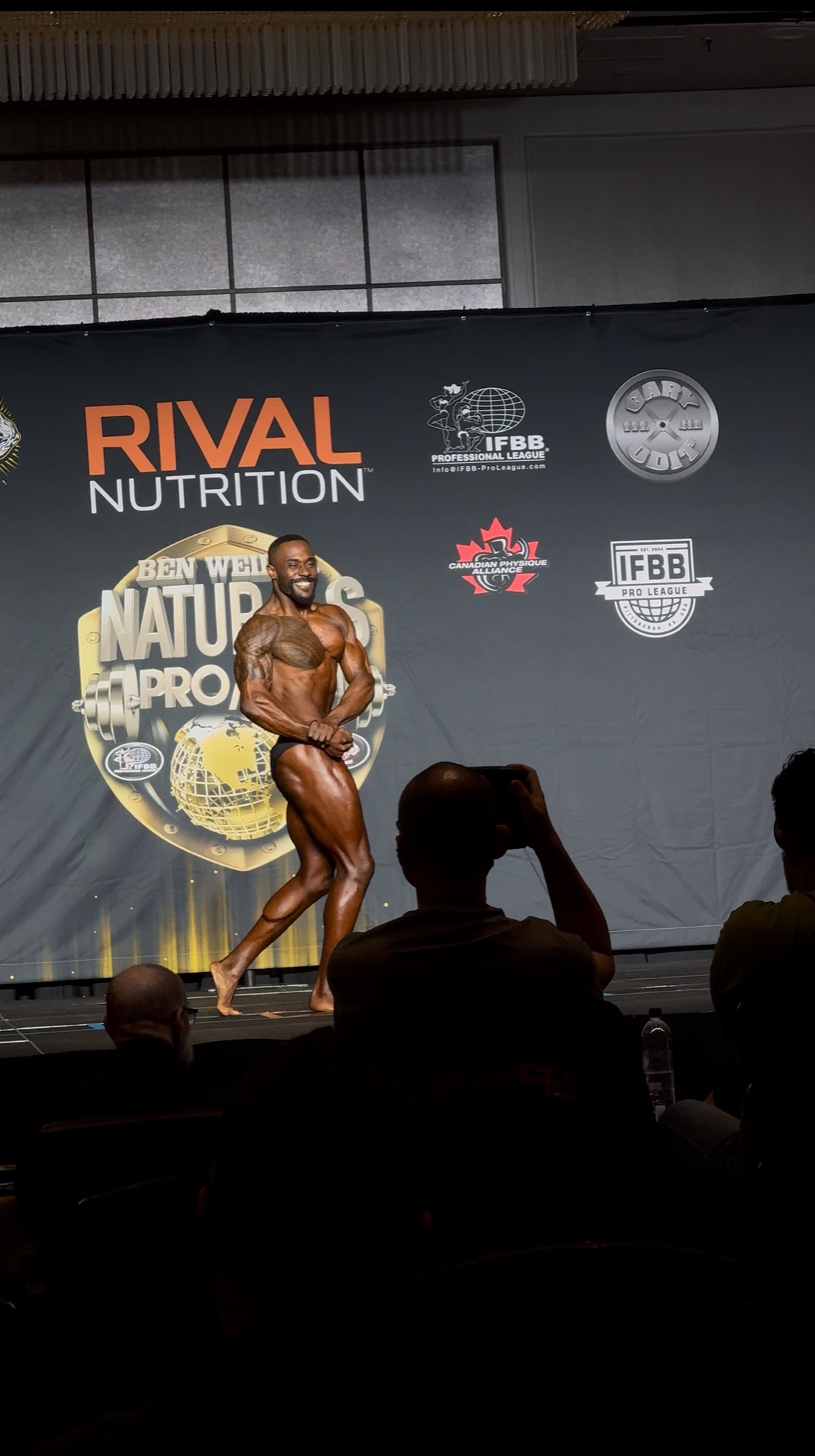 Russell Holland posing on the Ben Weider Naturals Pro stage